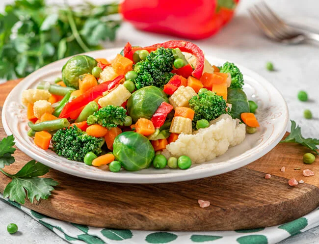 Mix of vibrant coloured vegetables on plate