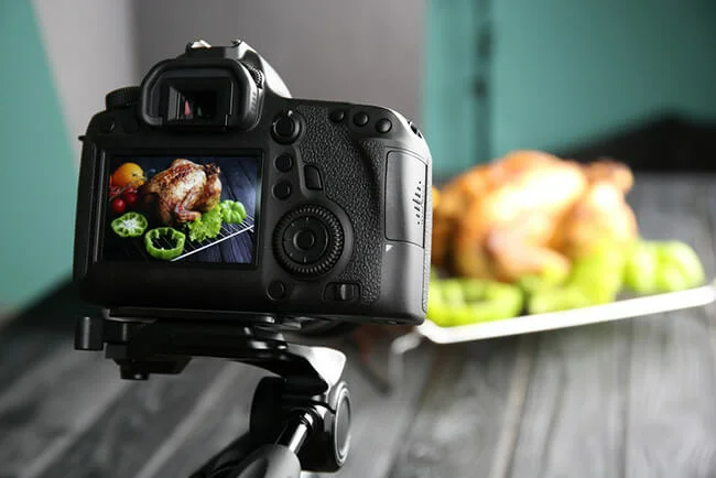 Professional camera on tripod during food photographing in studio