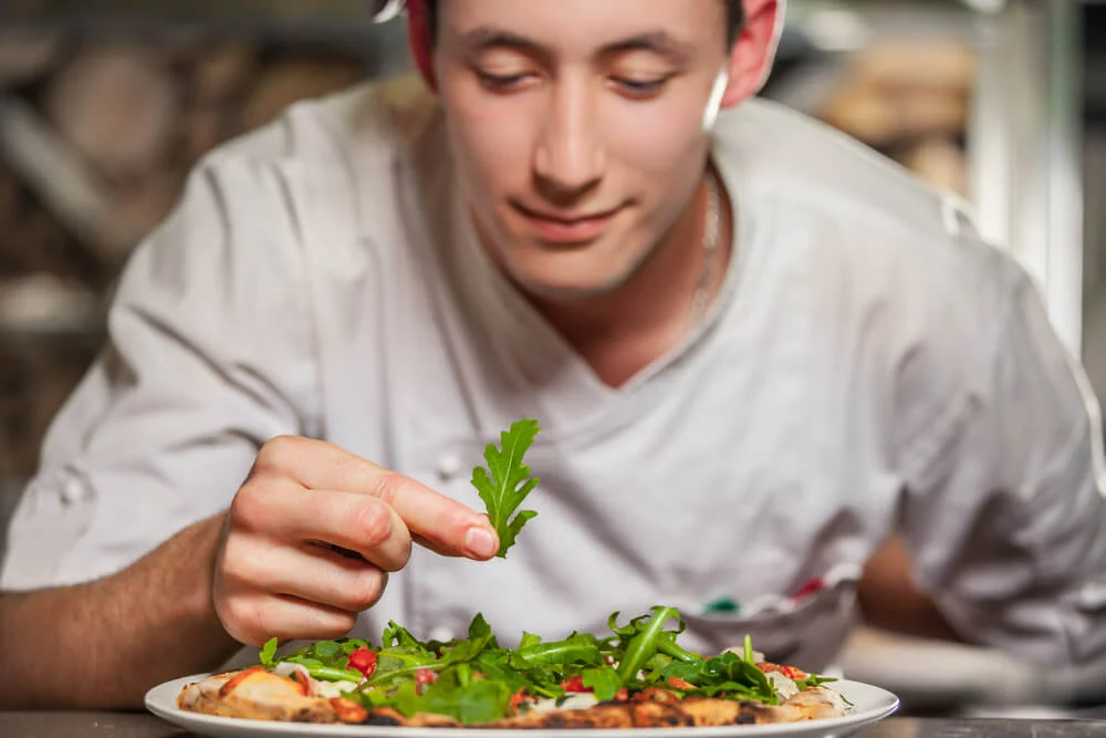 Chef decorating a dish