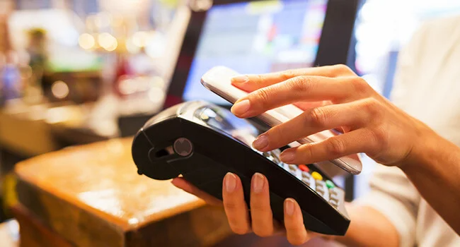 Café customer paying for order with NFC technology