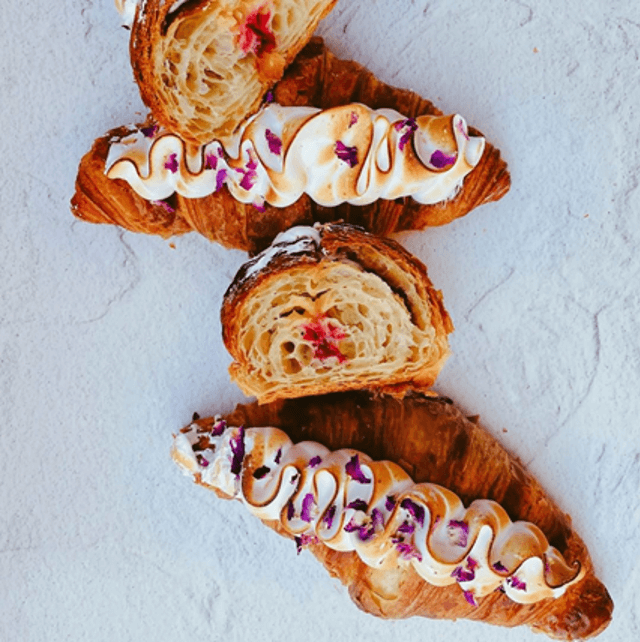 Lemon curd and raspberry croissant topped with meringue and rose petals from Luxe Bakery, New South Wales