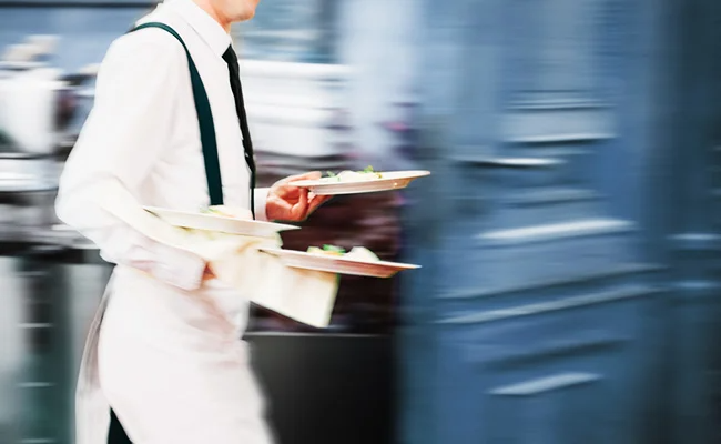 Waiter serving food