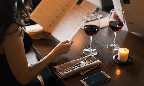 Couple at restaurant table browsing simple menu