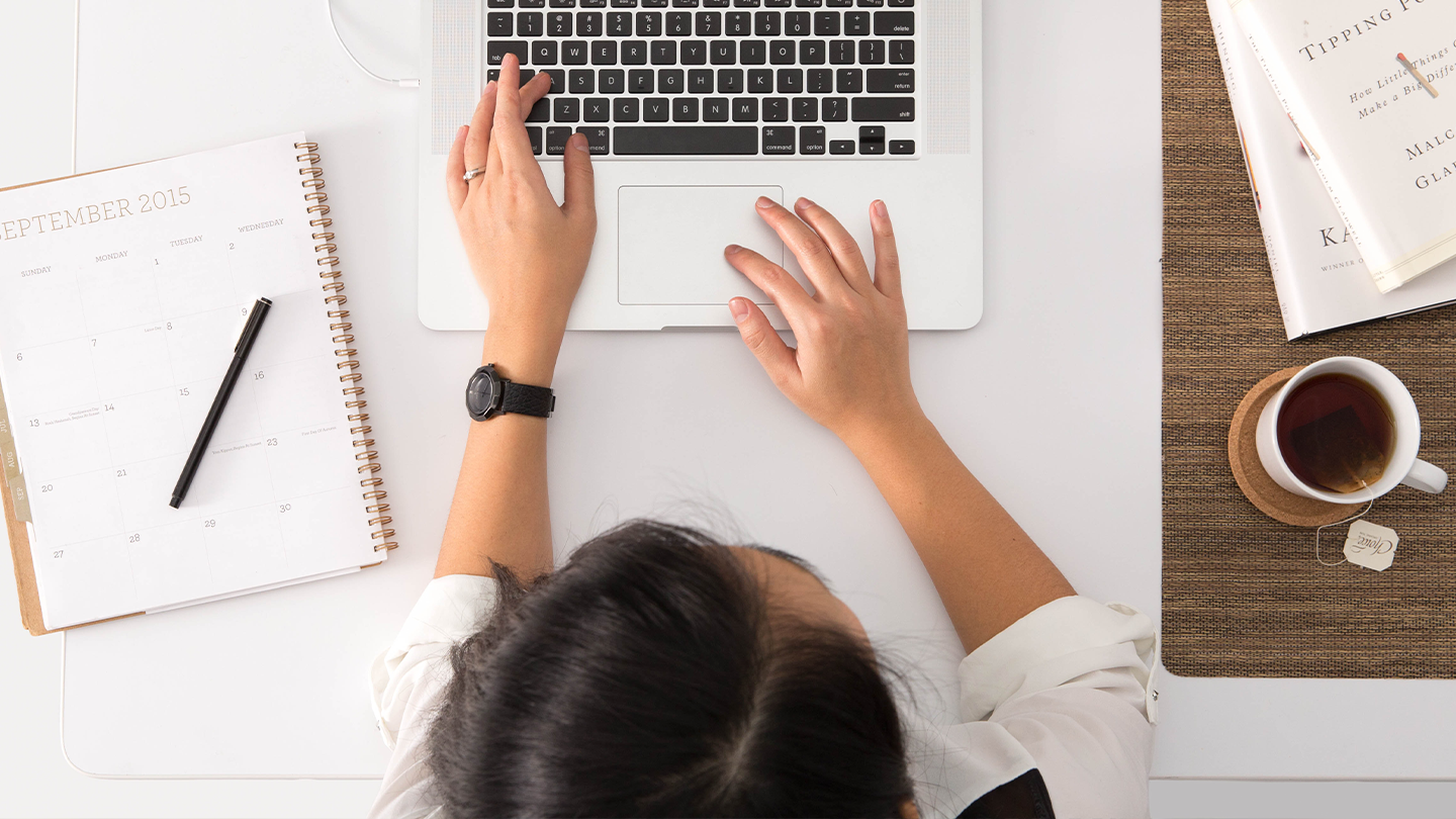 A Woman Typing On A Keyboard
