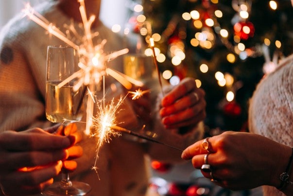 people holding wine glasses and sparklers