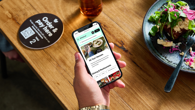 Customer scanning QR code menu with smartphone