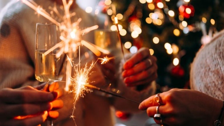 people holding wine glasses and sparklers