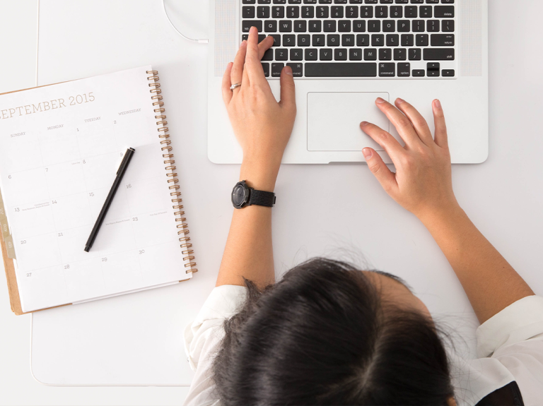 A Woman Typing On A Keyboard