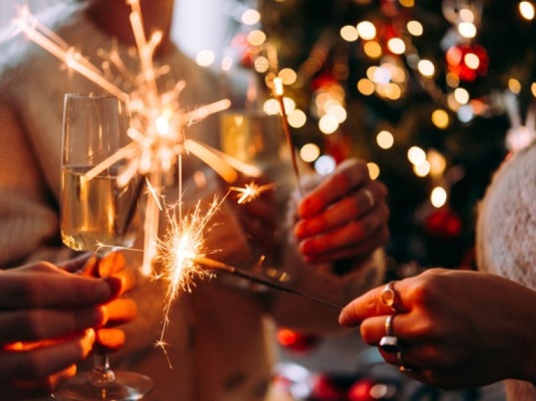 people holding wine glasses and sparklers