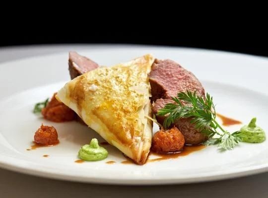 Sous vide lamb saddle marinaded in tom yum, Smoked Lamb neck filo, Dutch carrots, pea and mint gel, red pesto, jus and roaste