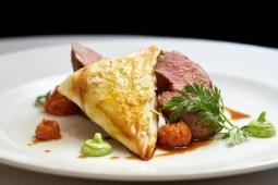 Sous vide lamb saddle marinaded in tom yum, Smoked Lamb neck filo, Dutch carrots, pea and mint gel, red pesto, jus and roaste