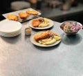 A perfectly crumbed chicken schnitzel, plated on a bed of lusciously silky and creamy Maggi Mash with coleslaw and a lemon we