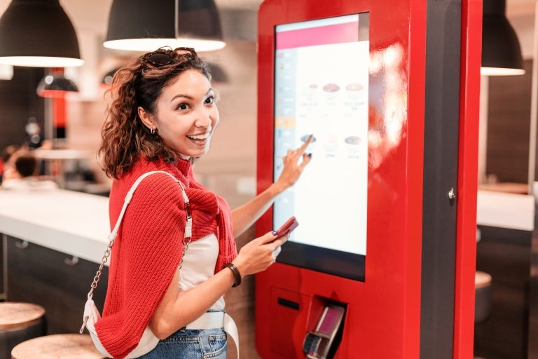 Smiling customer order through order counter